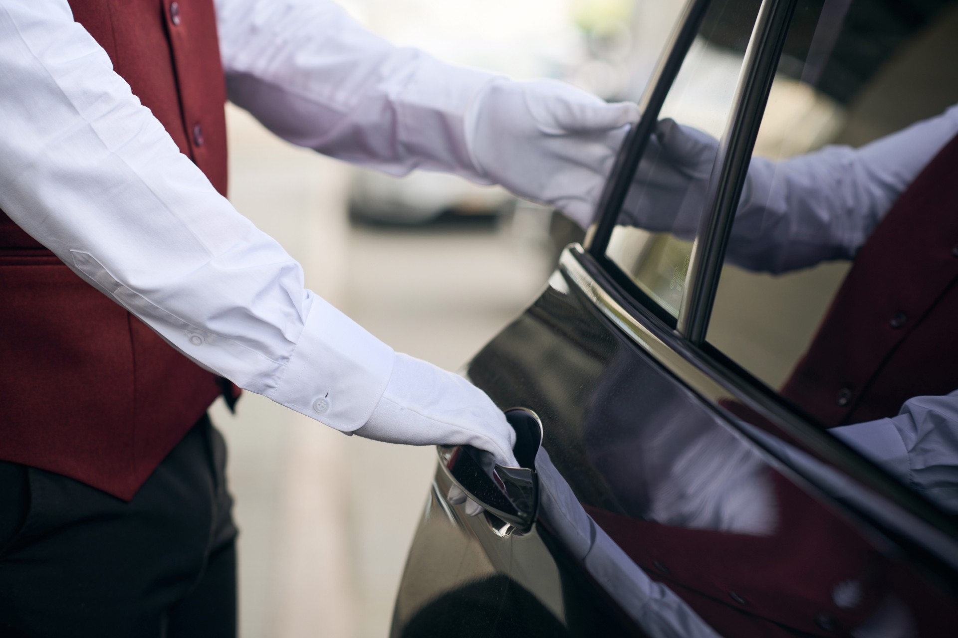 Doorman opening the door of the car